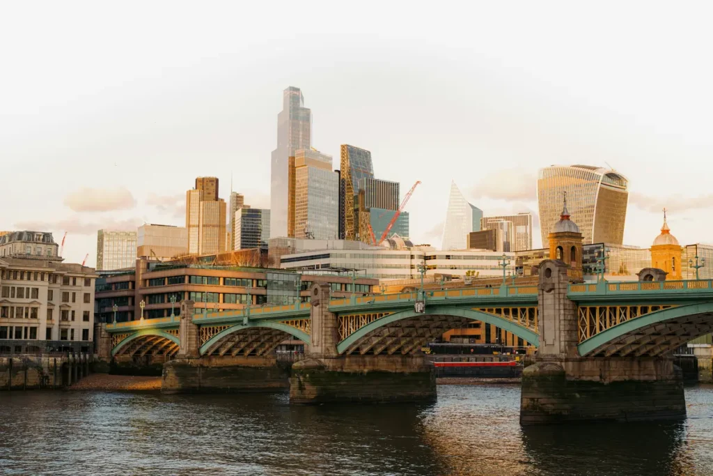 London skyline with a bridge and the river at sunset