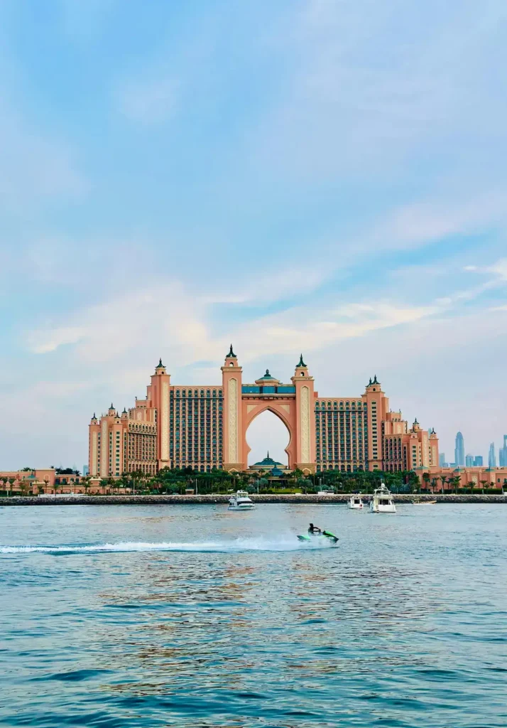 Large waterfront resort with a boat in front