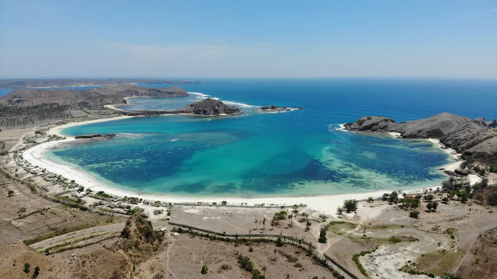 Aerial view of a curved white-sand bay in Lombok, Indonesia