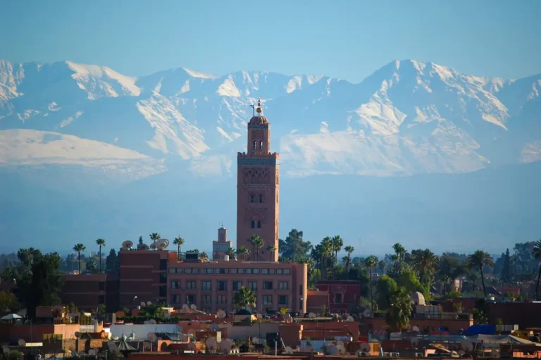 Koutoubia Mosque minaret in Marrakech with the Atlas Mountains